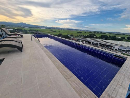a large swimming pool with blue tiles on a roof at A cozy and spacious Studio apartment Angeles city pampanga in Angeles