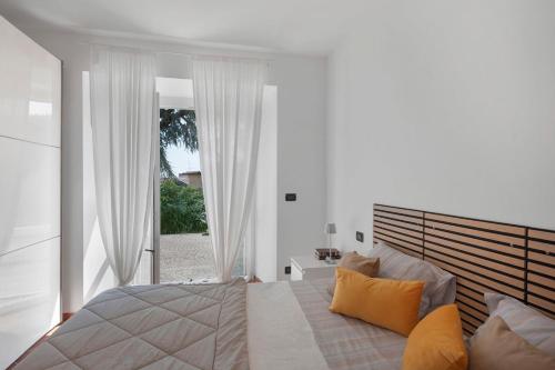 a bedroom with a large bed and a large window at Vacanza Nel Cuore Del Monferrato in Rocca Grimalda