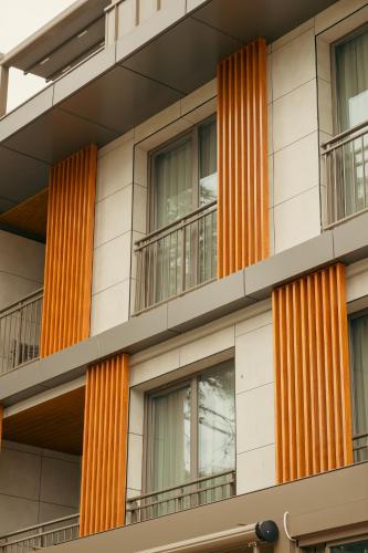 an orange and white building with windows and balconies at Bomo Suites in Antalya