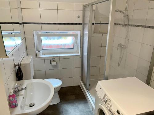 a bathroom with a toilet and a sink and a shower at Ferienwohnung Khorsandi Zwei in Coburg