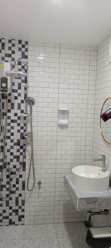 a bathroom with a shower and a sink at Lhong Luk Khao Camping in Ban Khlong Kathon