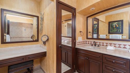 a bathroom with two sinks and a large mirror at Sonoran Sky in Puerto Peñasco