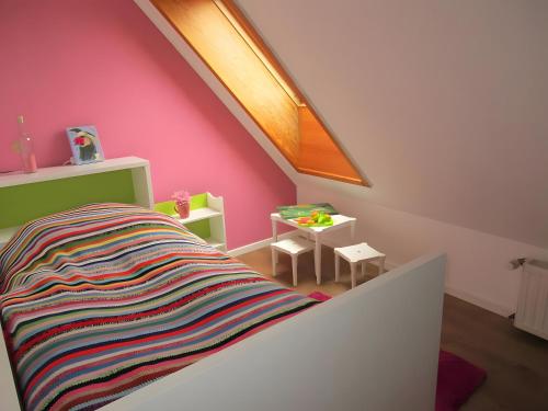 a childs room with a bed with a colorful blanket at Ferienwohnung Max und Moritz in Mirow