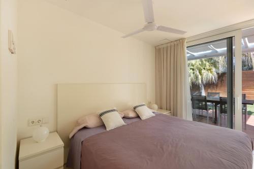 a bedroom with a bed and a large window at Casa Nirvana - Penthouse in Sitges