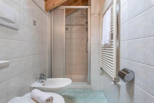 une salle de bain avec un lavabo, des toilettes et une douche dans l'établissement Ciasa Alfred App 4 Personen, à La Villa