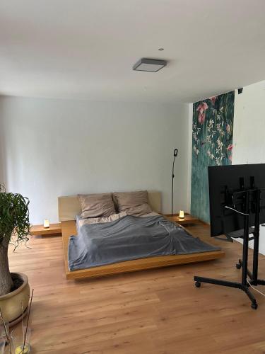 a bedroom with a bed and a desk in a room at Separate Area mit Schlafzimmer und Badezimmer in Heroldsberg