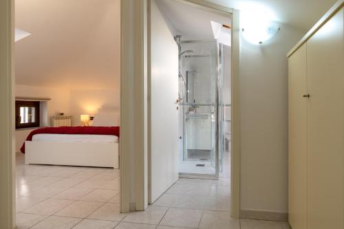 a bathroom with a shower and a bed in a room at La Terrazza House in Lanciano