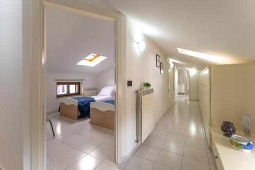 a hallway of a room with a bedroom and a bed at La Terrazza House in Lanciano