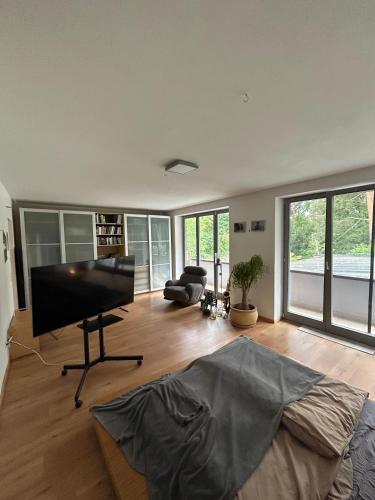 a living room with a bed and a piano at Separate Area mit Schlafzimmer und Badezimmer in Heroldsberg