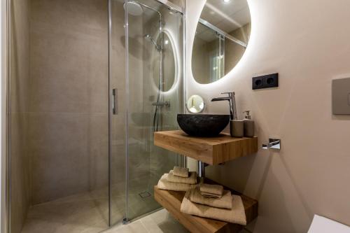 a bathroom with a sink and a glass shower at Casa Eva in Estepona