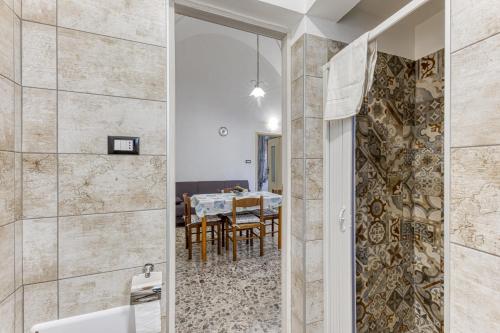 a bathroom with a shower and a dining room at Dimore degli innamorati in Presicce