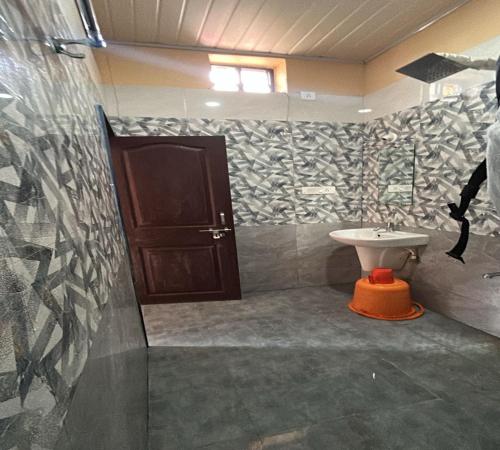 a bathroom with a toilet and a sink at Seeta residency in Gokarna