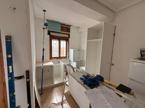 a kitchen being remodeled with a table and a window at Casa Eveline in Punta Prima