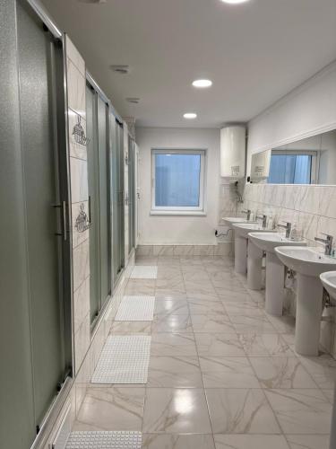 a bathroom with several sinks and a row of mirrors at Хостел "Батискаф" in Bila Tserkva