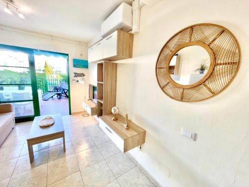 a living room with a mirror and a table at Paradise Dreams in Maspalomas