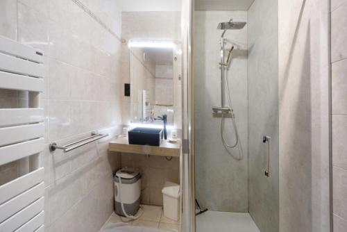 a white bathroom with a shower and a sink at Chez Stephane et Estelle in Villarodin-Bourget