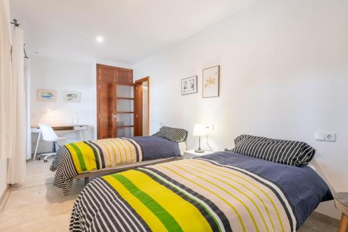 two beds with striped blankets in a room at Son Vivot Bill in Inca