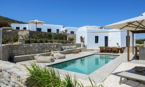 a villa with a swimming pool and a patio at ANOTERRA VILLAS -Anemone in Ambelas