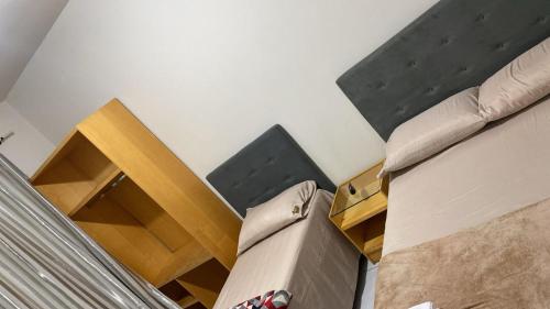 a room with two beds and a bed frame at Mega Hotel in Cascavel