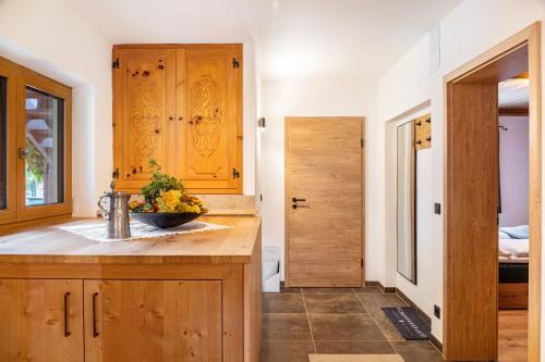 a kitchen with wooden cabinets and a counter top at Herzstück in Mittenwald