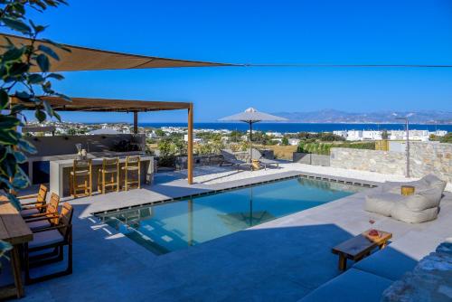 a villa with a swimming pool with a view at ANOTERRA VILLAS -Anemone in Ambelas
