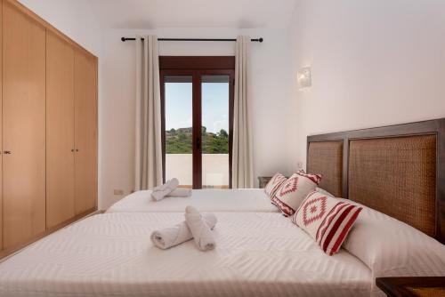 a bedroom with two stuffed animals on a bed at Florida Home in Casares