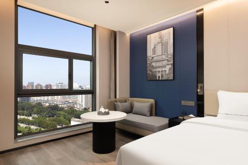 Postel nebo postele na pokoji v ubytování 啡诺美居