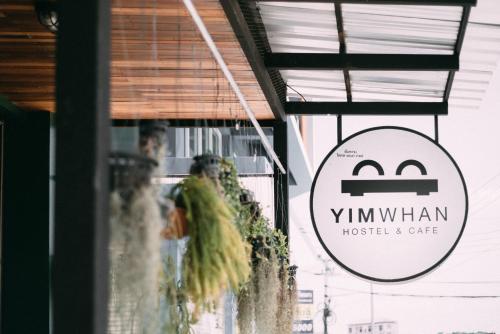 a sign for the window of a restaurant at Yimwhan Hostel & Cafe Ayutthaya in Phra Nakhon Si Ayutthaya