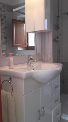 a bathroom with a white sink and a mirror at da Ciccio e Concy in Tursi