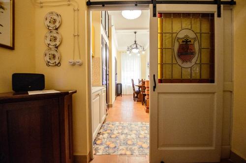 a hallway with a door with a stained glass window at Rinascimento Suite Centro Storico Modena in Modena