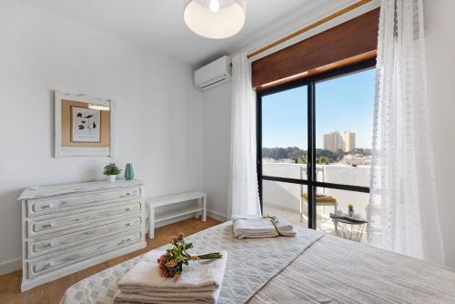 アルヴォルにあるDreamalvorのベッドとドレッサーと窓のある寝室