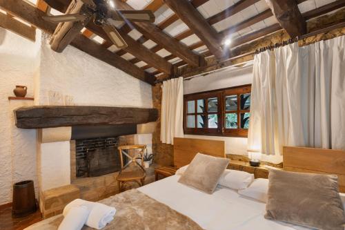 a bedroom with a bed and a fireplace at Mas Juli in Pineda de Mar