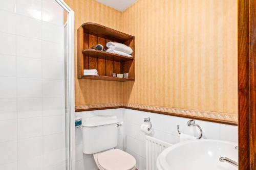 a bathroom with a toilet and a sink at The Honest Lawyer, an Ascend Collection Hotel in Nelson