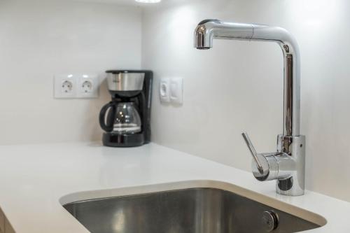 a kitchen counter with a sink and a coffee maker at Casa Tiago in Santa Cruz de Tenerife