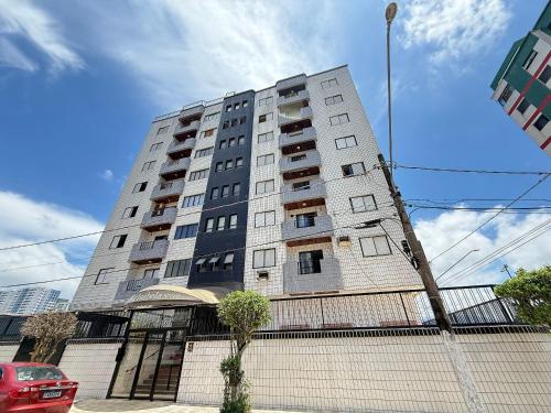 a tall building with balconies on the side of it at Pé Na Areia Praia da Ocean III in Samaritá