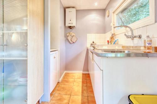 a small kitchen with a sink and a window at Gite Le Pont in Varaignes