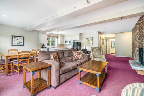 a living room with a couch and a table at The Valley Inn, an Ascend Collection Hotel in Waterville Valley