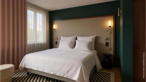 a bedroom with a large white bed and a window at Hotel 2M, The Originals Relais in Saint-Just-Saint-Rambert