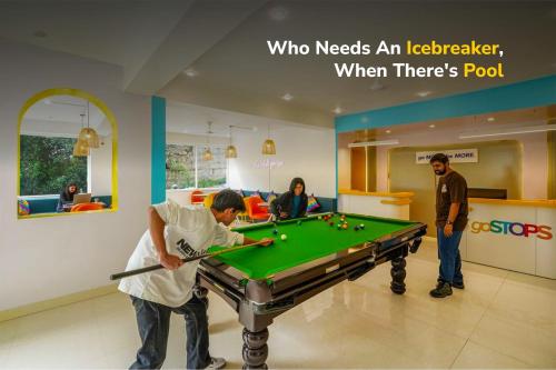 a group of people playing pool in a store at goSTOPS Mcleodganj, Bhagsu in McLeod Ganj