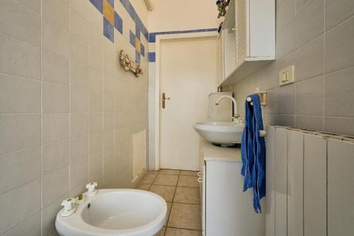 a bathroom with a toilet and a sink at A Casa Di Ilde in Follonica