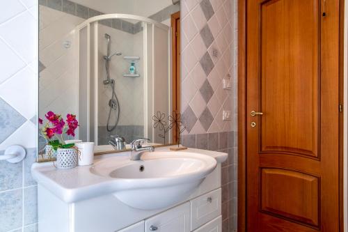 a bathroom with a white sink and a shower at The Terrace Above The Sea in Castelsardo