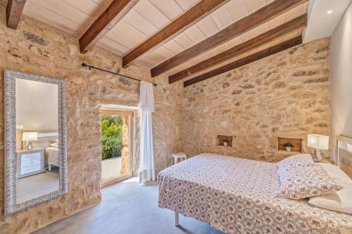a bedroom with a bed and a large mirror at Can Xesquet - Morell in Ses Salines