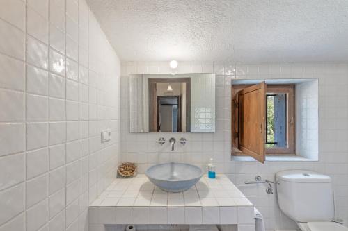 a bathroom with a sink and a toilet at Can Marc in Dosríus