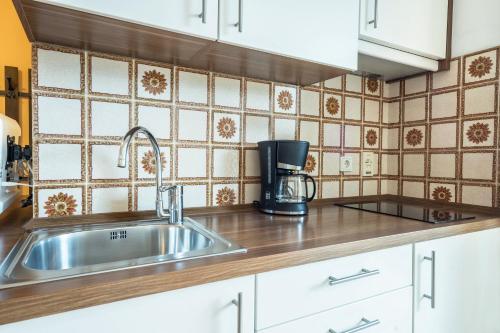 a kitchen with a sink and a coffee maker at Residence Kronstein - Fewo 2 in Tesimo