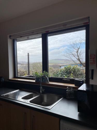 a kitchen counter with a sink and a window at No 1 High Park Lodges in Orkney