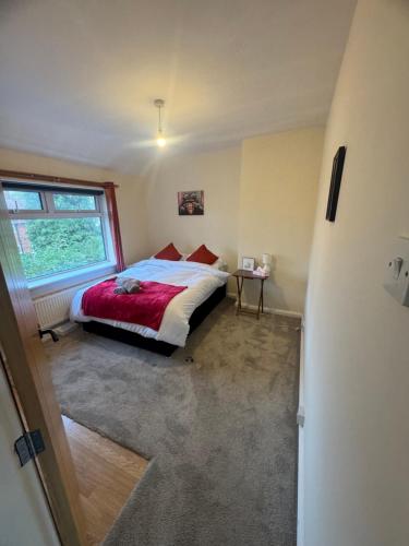 a bedroom with a bed and a large window at Cosy 3 Bedroom in Birmingham in Birmingham