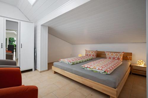 a bedroom with a bed with two pillows on it at Storchensommer in Blankensee