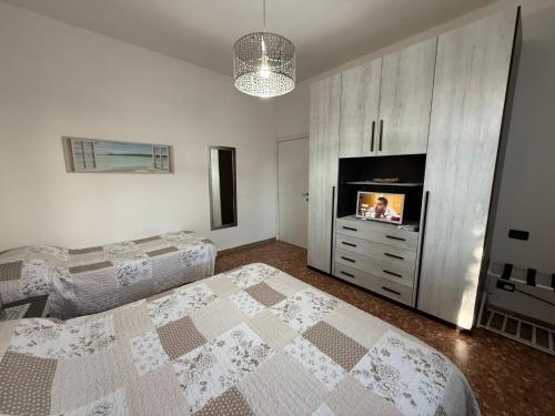 Un dormitorio con dos camas y un televisor de pantalla plana. en Casa vacanze Antonia, en Bolonia