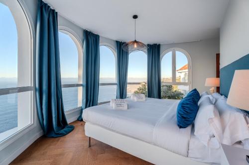 a bedroom with a bed and large windows at Karat Villa Sound of the Sea in Tacoronte