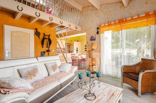 a living room with a white couch and a table at Charmant Gite Egaux De Chambon in Chambon